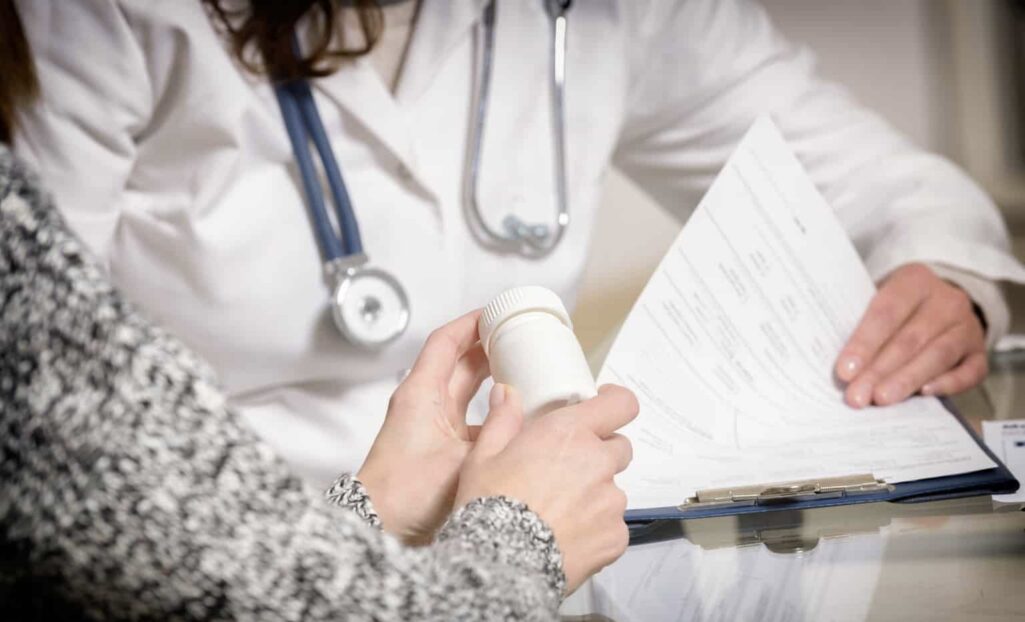 Doctor prescribing pills to patient