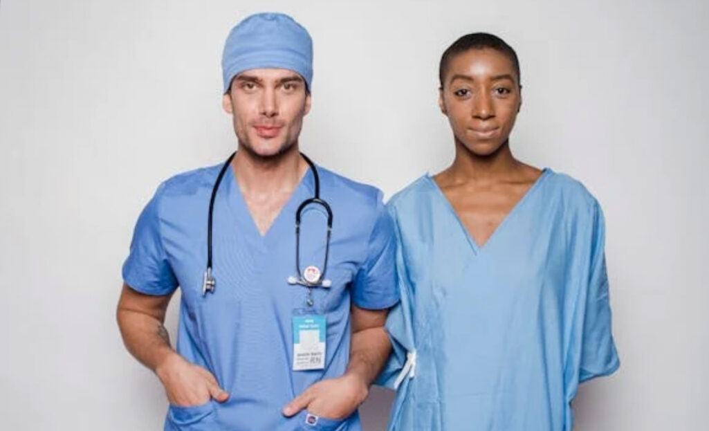 Two healthcare workers in blue scrubs