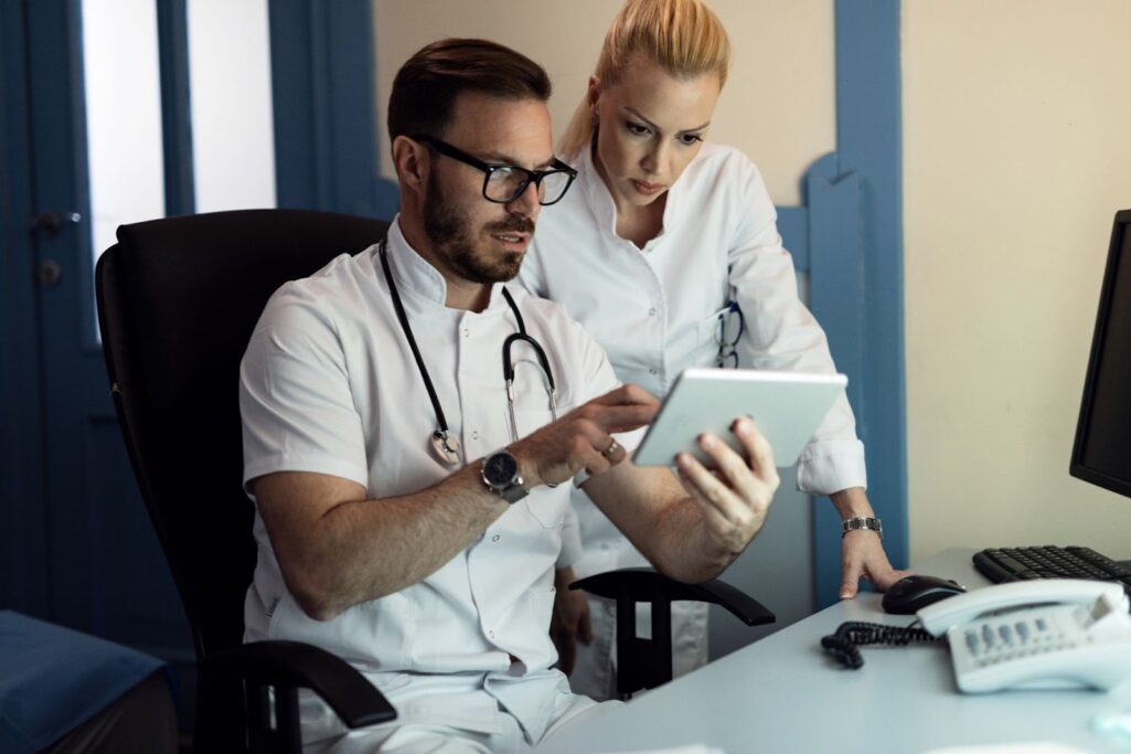 Male doctor and nurse cooperating and discussing work