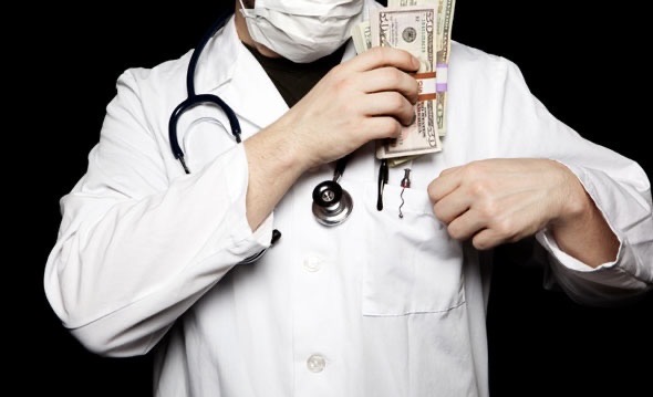Doctor putting money in his pocket