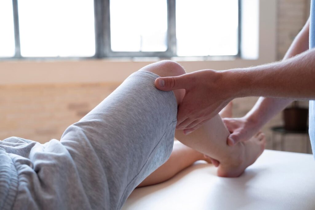 Doctor checking patient's leg