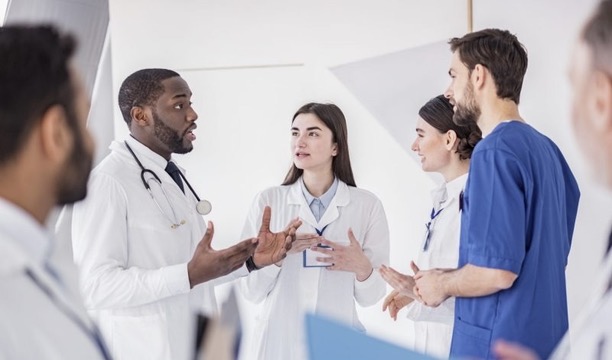 A doctor communicates with a group of assistants