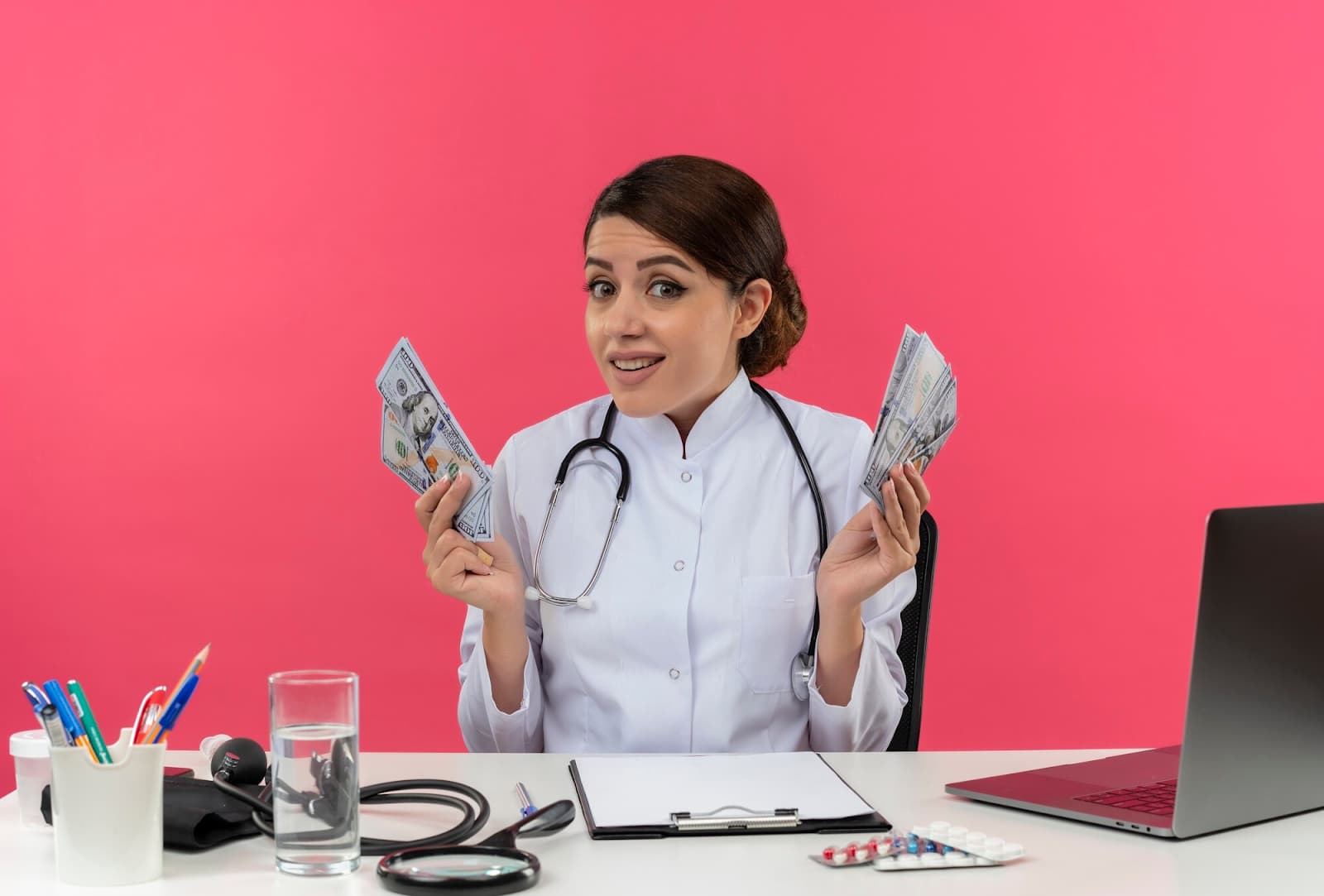 A woman doctor in a medical gown sits at the table and holds money