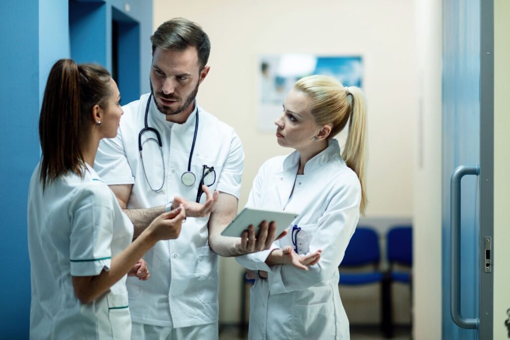 Team of doctors talking in a hallway at clinic