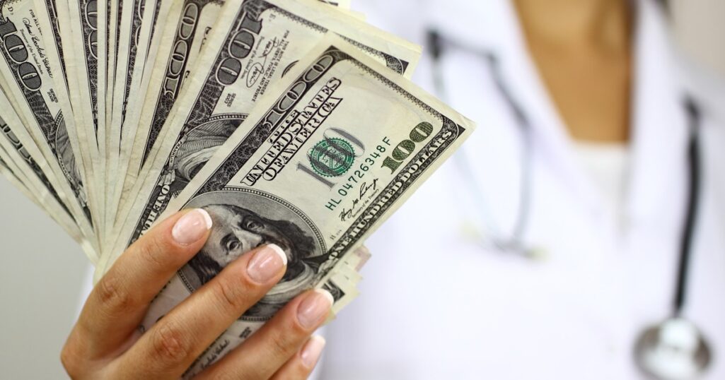 Hand holding dollars
